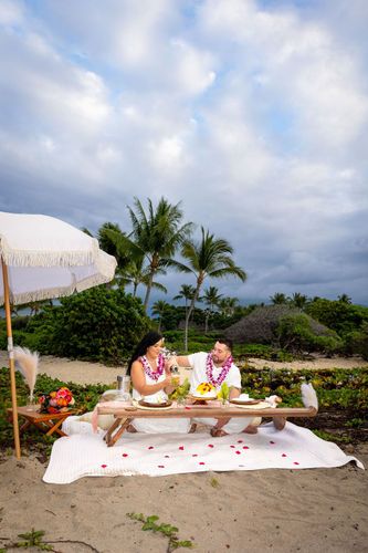 Beach picnic table with tropical setup, palm trees, and blue sky in Hawaii