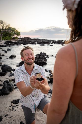 A man proposing to a woman on the beach in Hawaii